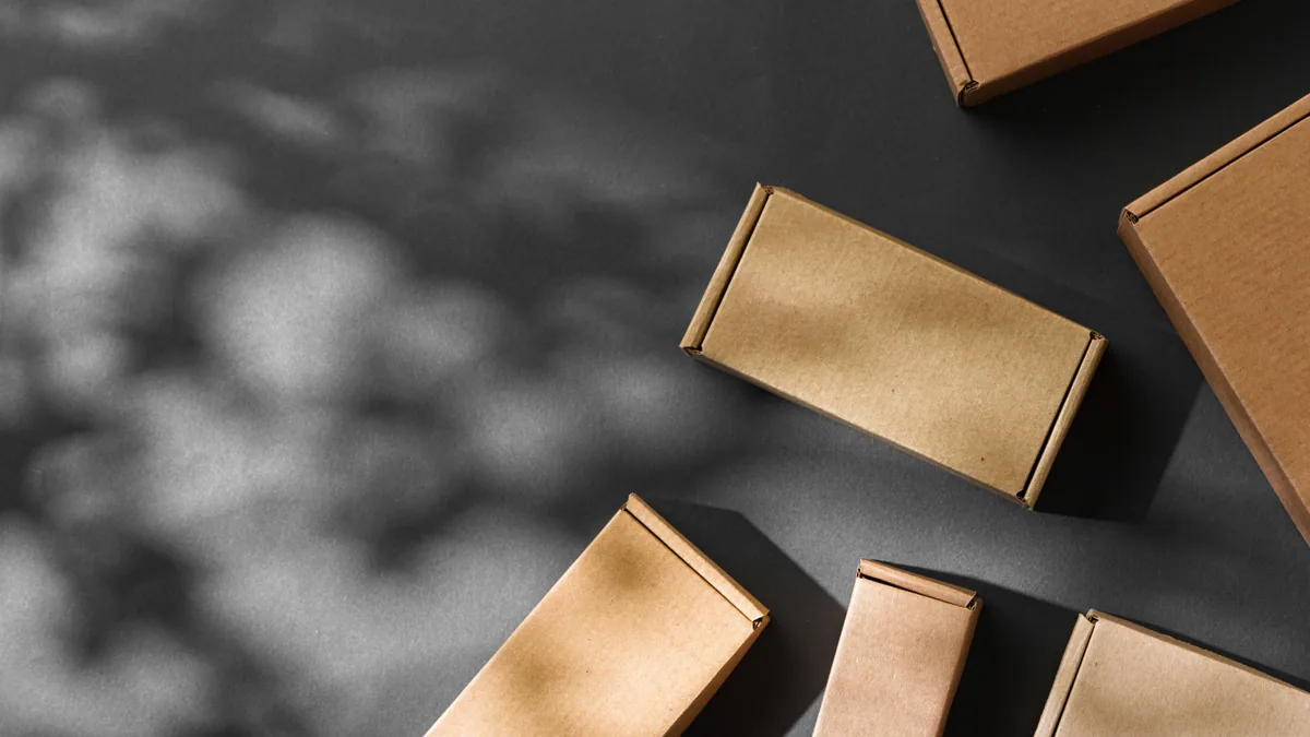 Brown cardboard boxes arranged on a grey background